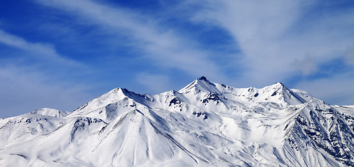 Image showing Panoramic view on winter snowy mountains in windy day