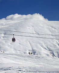 Image showing Gondola lift and ski slope at sun day