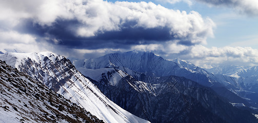 Image showing Panoramic view on winter mountains in evening and cloudy sky