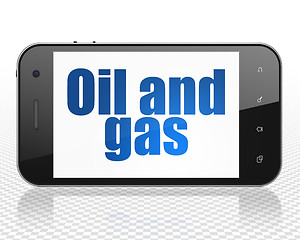 Image showing Manufacuring concept: Smartphone with Oil and Gas on display