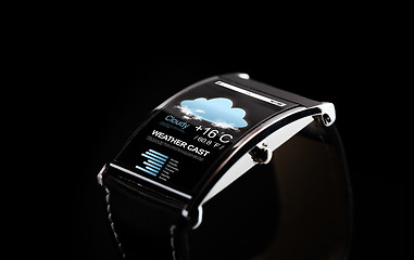 Image showing close up of black smart watch with weather cast
