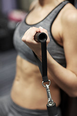 Image showing close up of woman exercising on gym machine