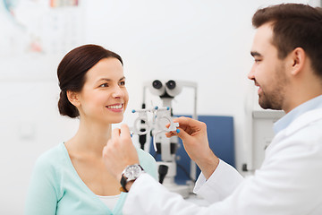 Image showing optician with trial frame and patient at clinic