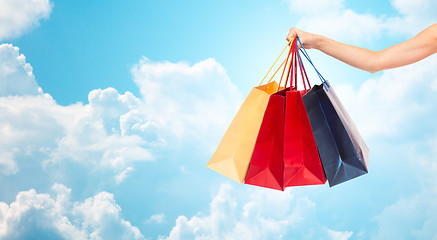 Image showing close up of female hand holding shopping bags