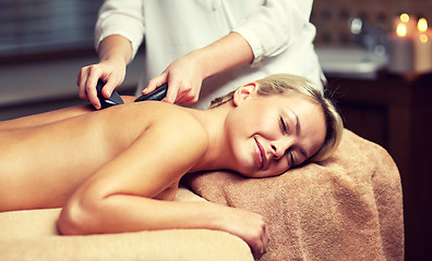 Image showing close up of woman having hot stone massage in spa