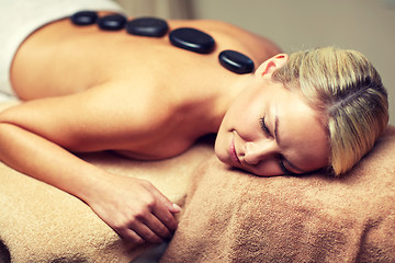 Image showing close up of woman having hot stone massage in spa