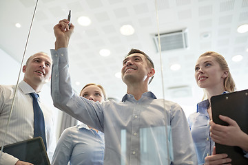 Image showing smiling business people with marker and stickers