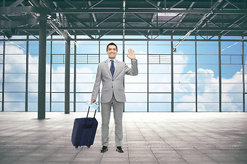 Image showing businessman with travel bag and ticket at airport