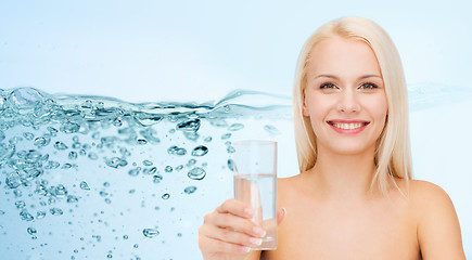 Image showing young smiling woman with glass of water