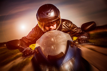 Image showing Biker racing on the road