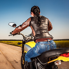 Image showing Biker girl on a motorcycle