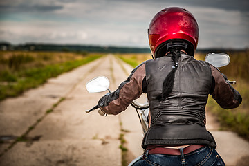 Image showing Biker girl on a motorcycle