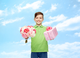 Image showing happy boy holding flower bunch and gift box