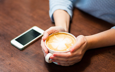 Image showing close up of woman with smartphone and coffee