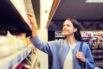 Image showing happy woman choosing and buying food in market