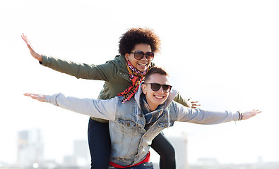 Image showing happy teenage couple in shades having fun outdoors