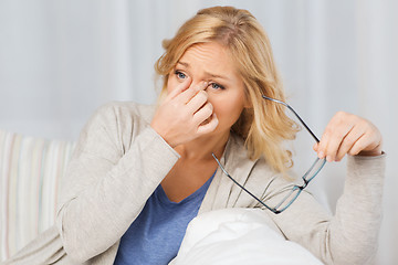 Image showing tired woman taking eyeglasses offhome