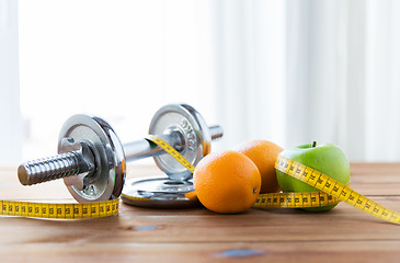 Image showing close up of dumbbell, fruits and measuring tape