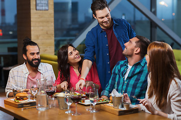 Image showing friends dining and drinking wine at restaurant