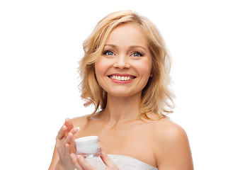 Image showing happy woman with cream jar