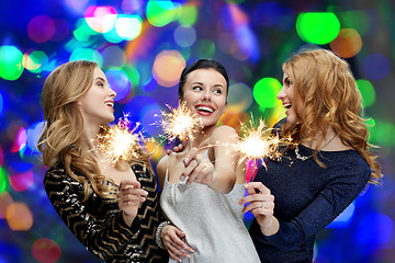 Image showing happy young women with sparklers over lights