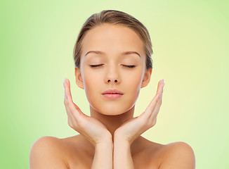 Image showing young woman face and hands over green