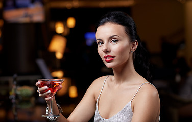 Image showing glamorous woman with cocktail at night club or bar