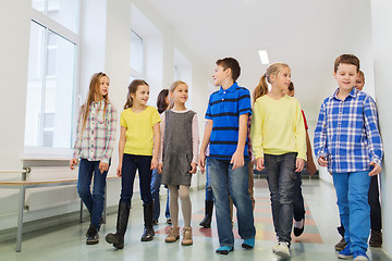 Image showing group of smiling school kids walking in corridor