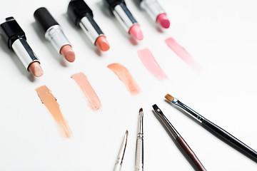 Image showing close up of lipsticks range with makeup brushes