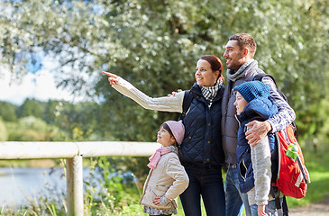 Image showing happy family with backpacks hiking