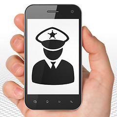 Image showing Protection concept: Hand Holding Smartphone with Police on display