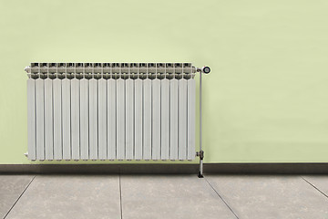 Image showing Gray radiator on a yellow wall