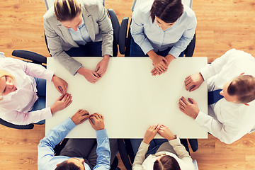 Image showing close up of business team sitting at table