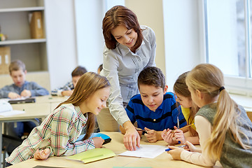 Image showing group of school kids writing test in classroom