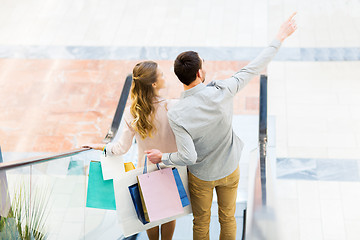 Image showing happy young couple with shopping bags in mall