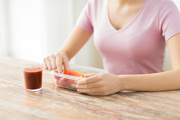 Image showing close up of woman with food in plastic container