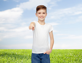 Image showing happy boy in white t-shirt pointing finger to you