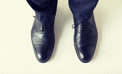 Image showing close up of man legs in elegant shoes with laces