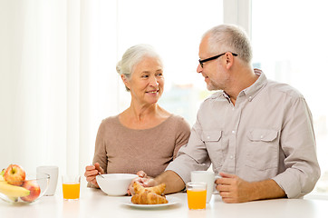 Image showing happy senior couple having breakfast at home