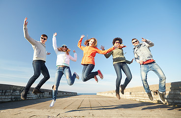 Image showing smiling friends in sunglasses laughing on street