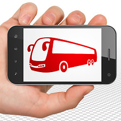 Image showing Travel concept: Hand Holding Smartphone with Bus on display