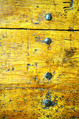 Image showing metal nail dirty  yellow  stripped paint in the brown    
