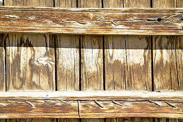 Image showing metal nail   in the brown   red wood door  