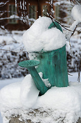 Image showing one old watering can with snow