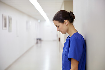 Image showing sad female nurse at hospital corridor