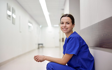 Image showing smiling female nurse at hospital corridor