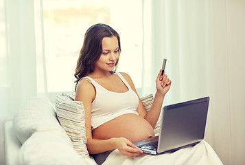 Image showing pregnant woman with laptop and ultrasound image
