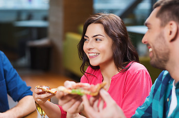 Image showing friends eating pizza with beer at restaurant