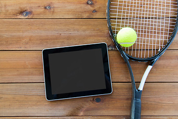 Image showing close up of tennis racket with ball and tablet pc