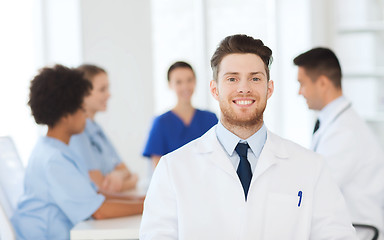 Image showing happy doctor over group of medics at hospital